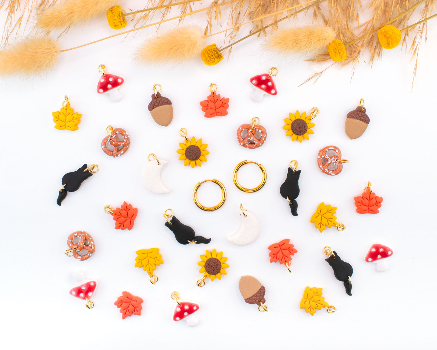 Fall-inspired handmade hoop earrings collection with interchangeable polymer clay charms.