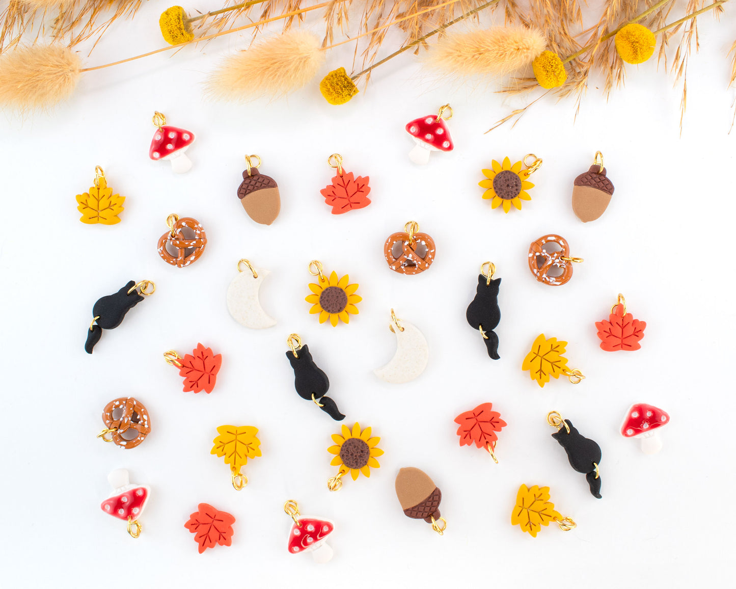 Fall-inspired handmade hoop earrings collection with interchangeable polymer clay charms.