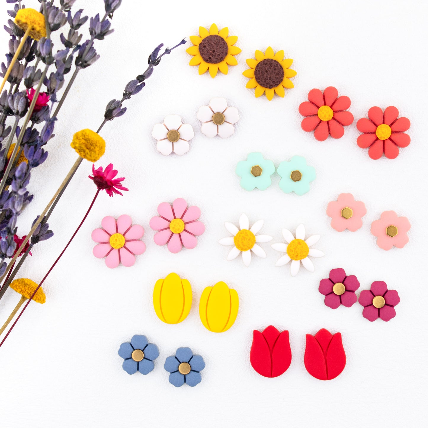 clay flower earrings are the perfect floral touch for any outfit! Choose from daisies, tulips, sunflowers, and colorful flowers to mix and match and create your own look.