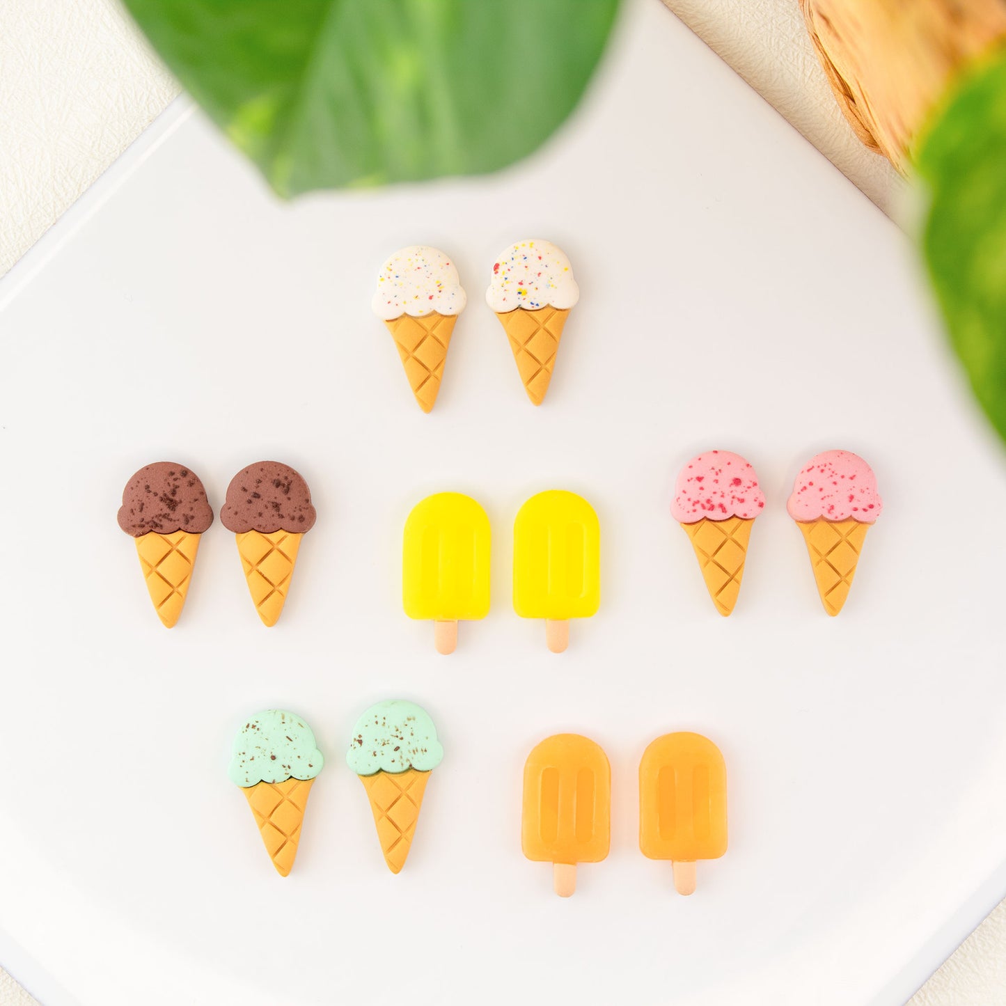 clay stud earrings shaped like colorful ice cream cones and popsicles