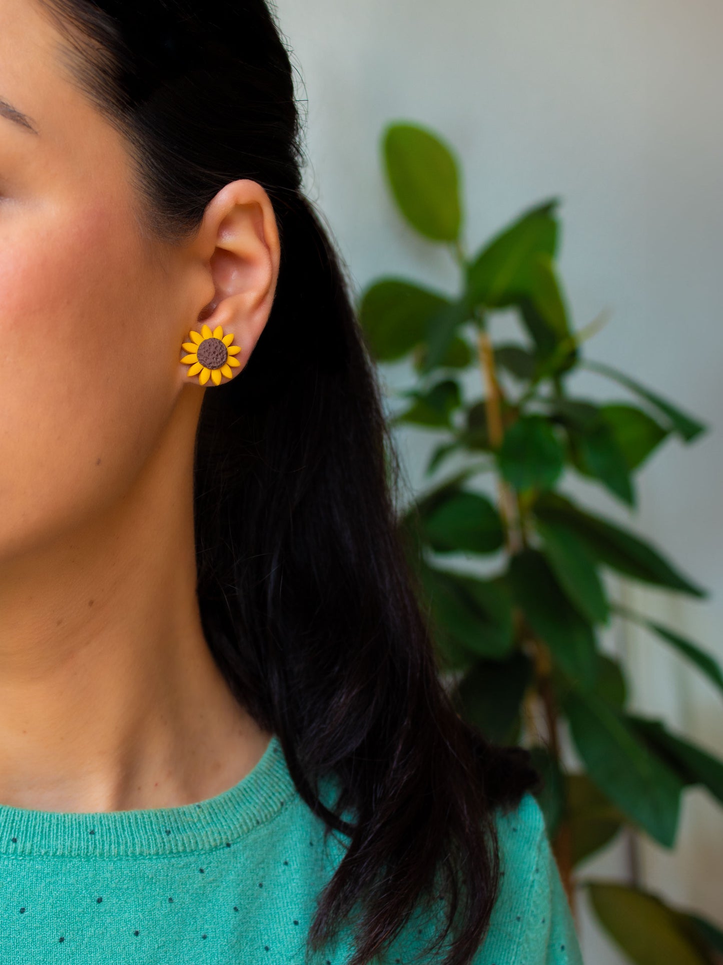 Model with sunflower stud earrings