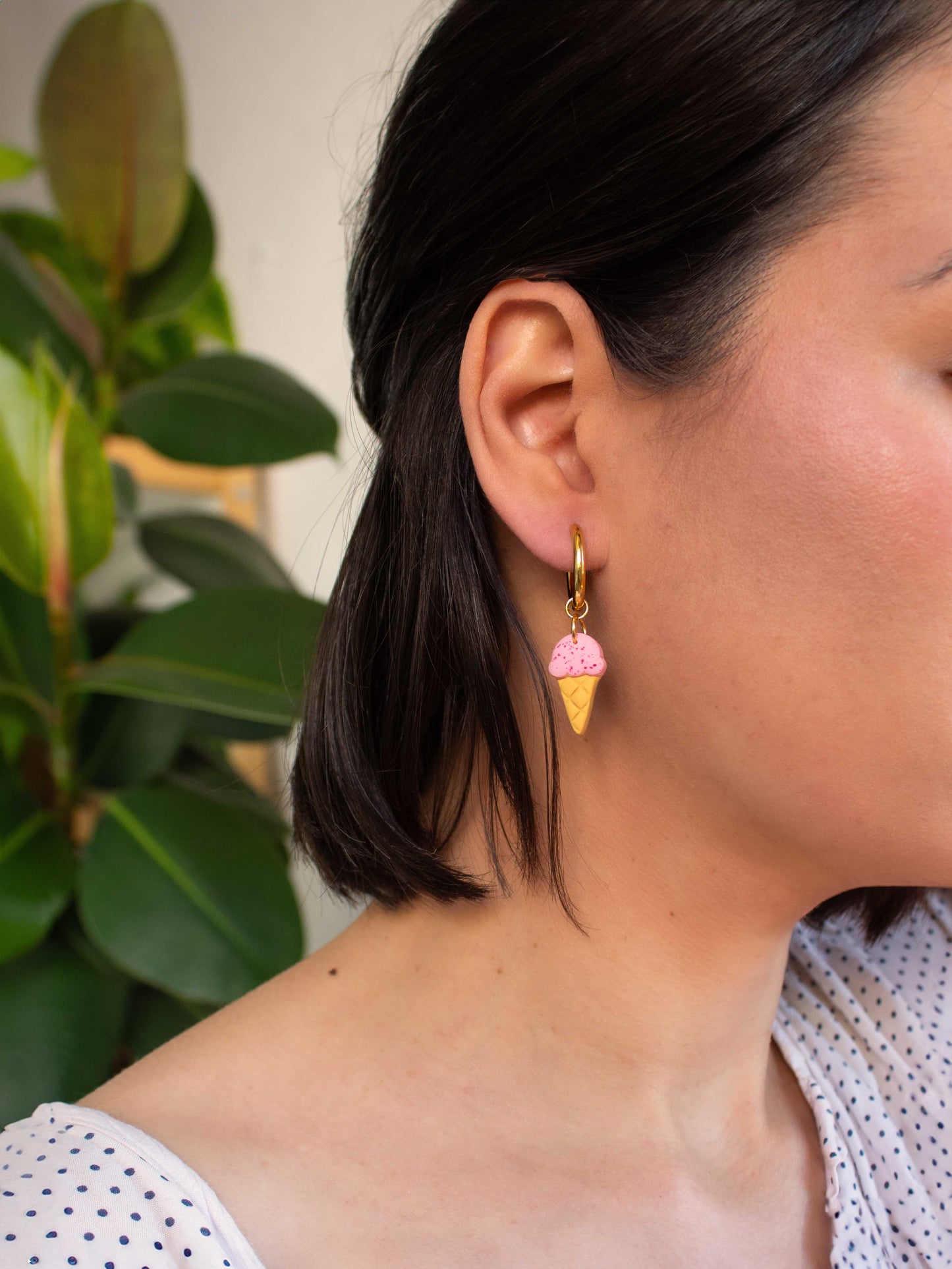 model wearing gold hoop earring with pink ice cream cone charm summer jewelry