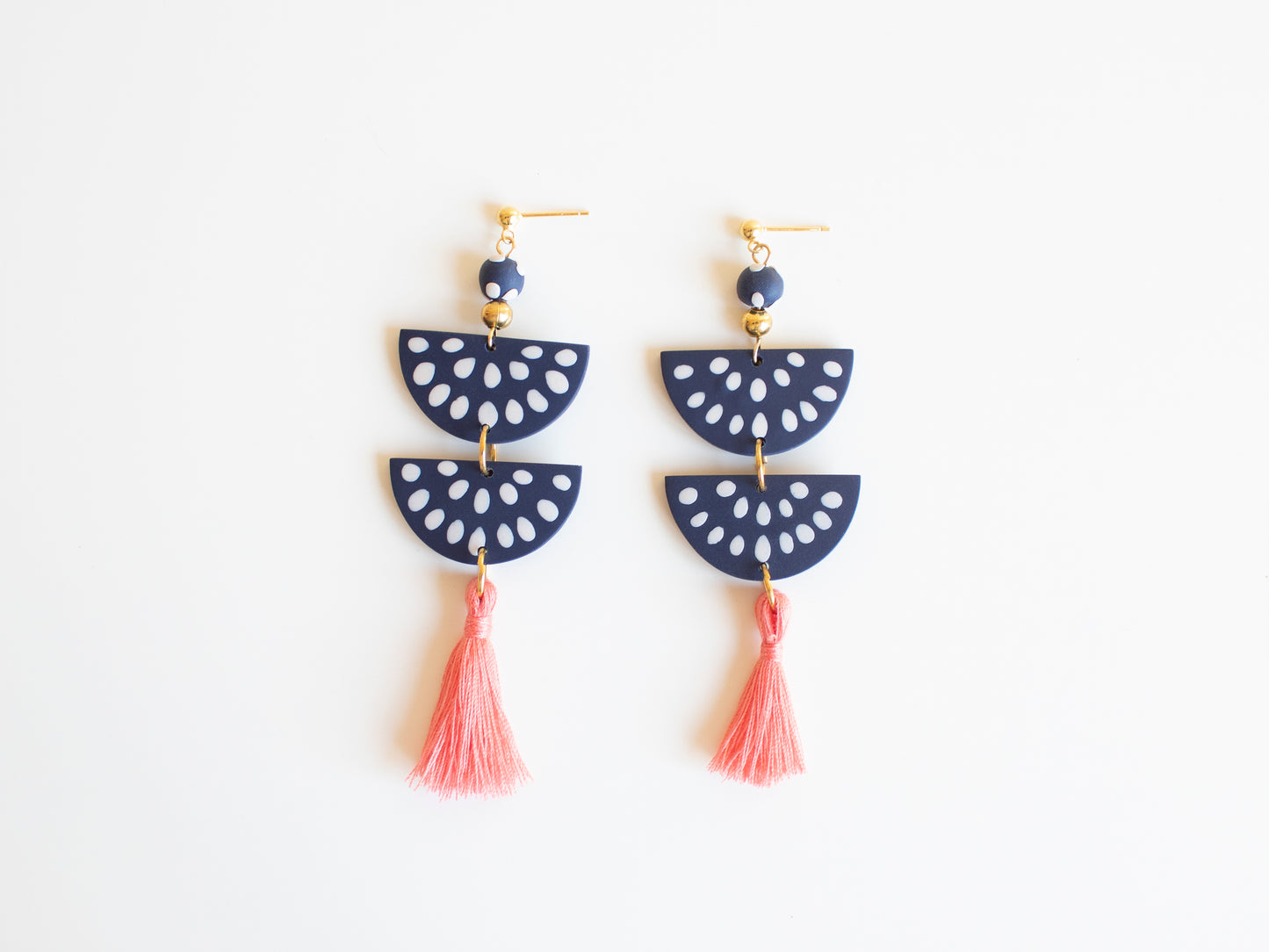 Handmade clay earrings in navy blue with customizable tassel options.