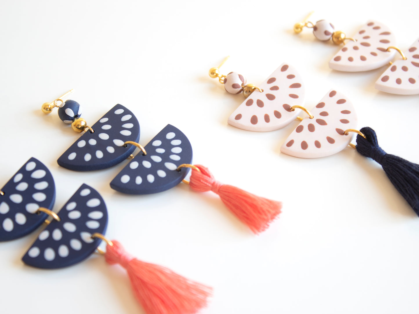 Personalized handmade earrings with interchangeable tassels in vibrant colors.