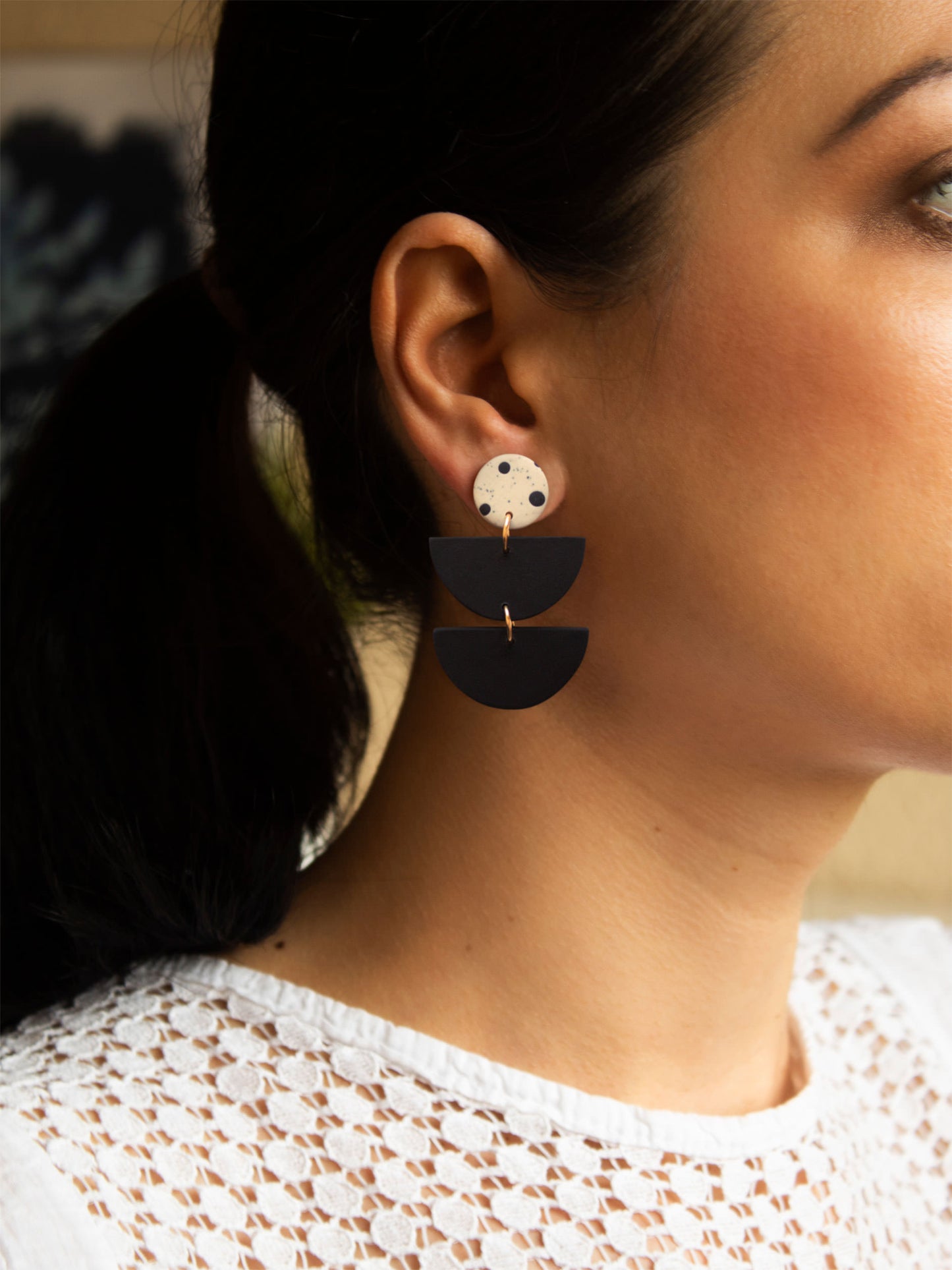Black and white boho dangle earrings, handmade with hypoallergenic materials.
