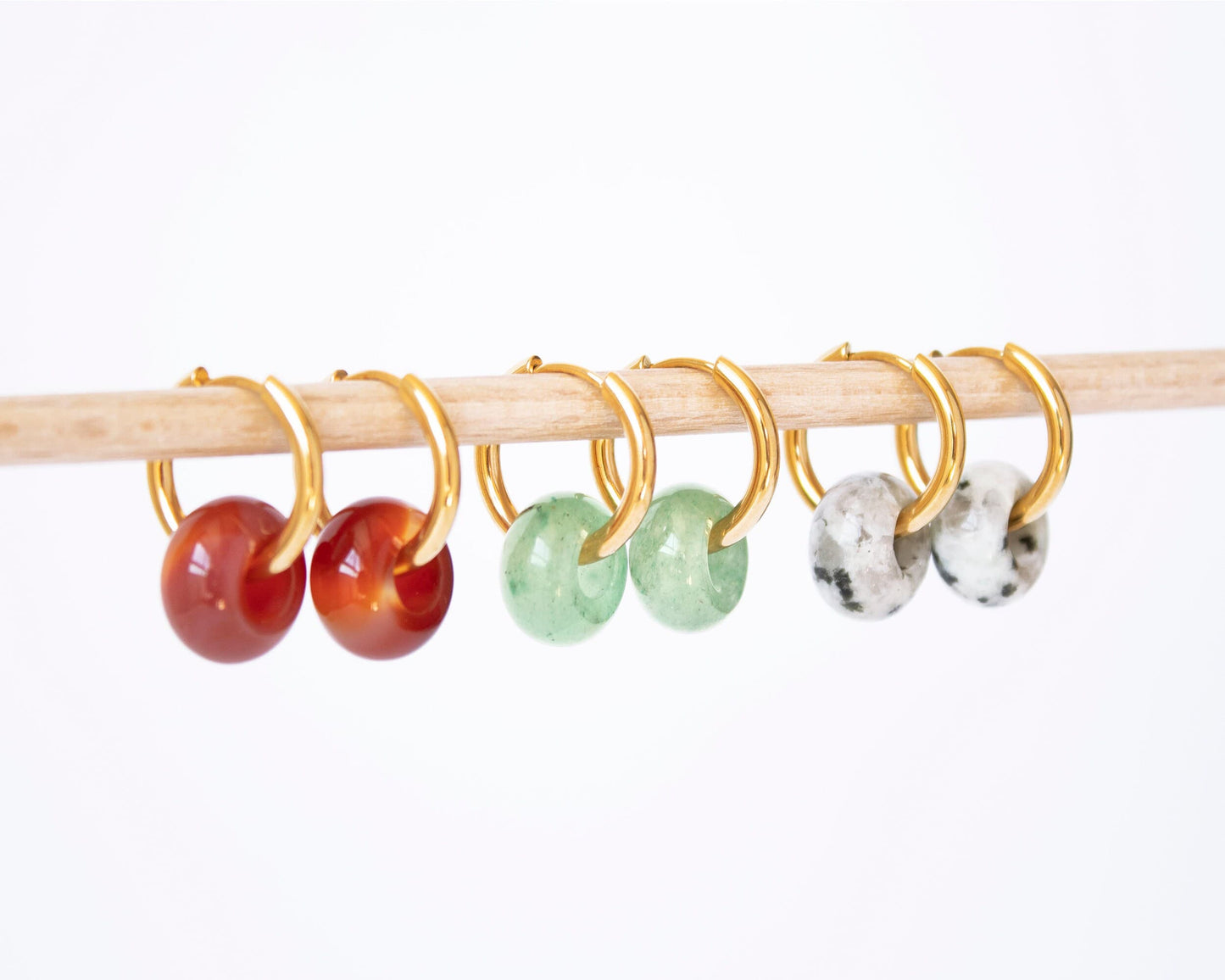 Set of three donut gemstone hoop earrings in Aventurine, Carnelian, and Dalmatian Jasper, displayed together