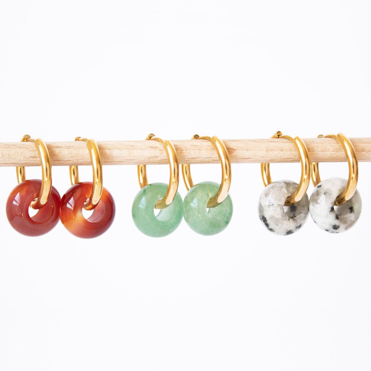 Set of three donut gemstone hoop earrings in Aventurine, Carnelian, and Dalmatian Jasper, displayed together