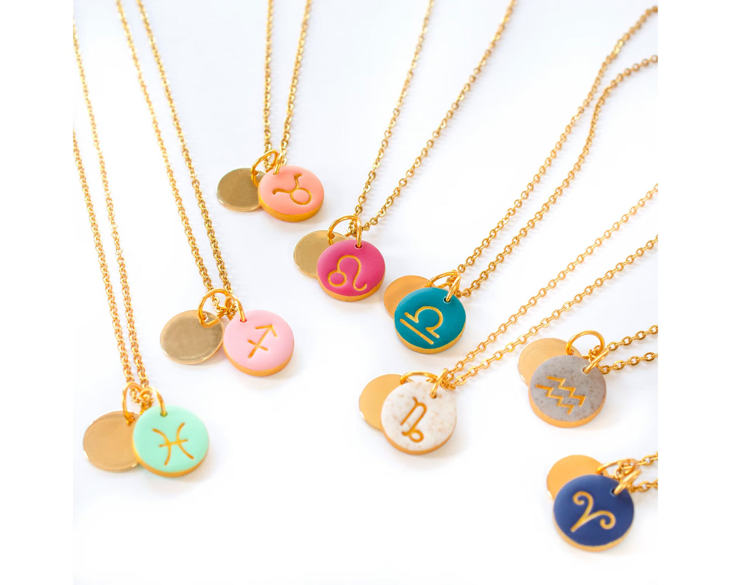 Colorful zodiac initial charms displayed for custom necklaces