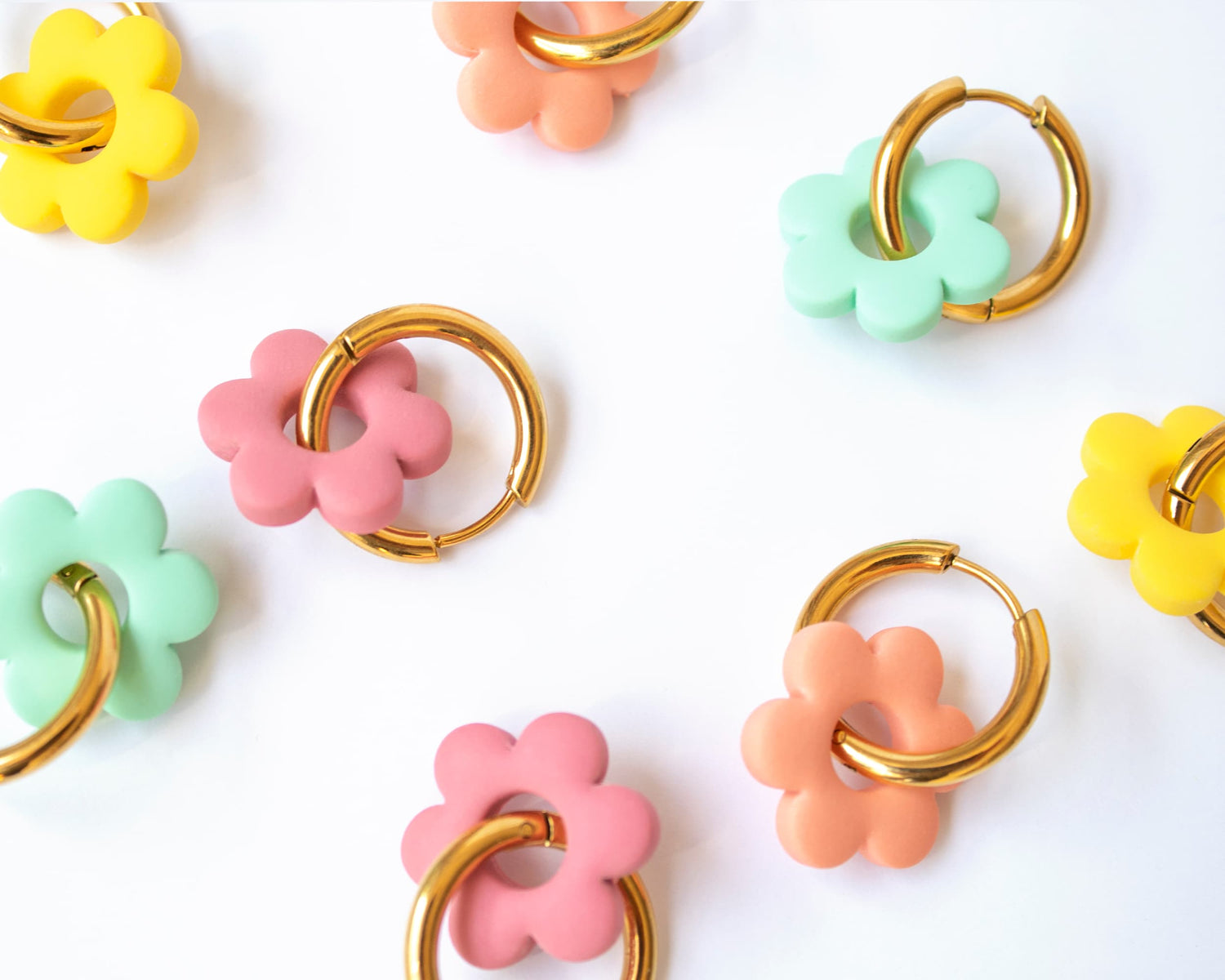 Close-up of hypoallergenic gold plated hoop earrings with handmade charms