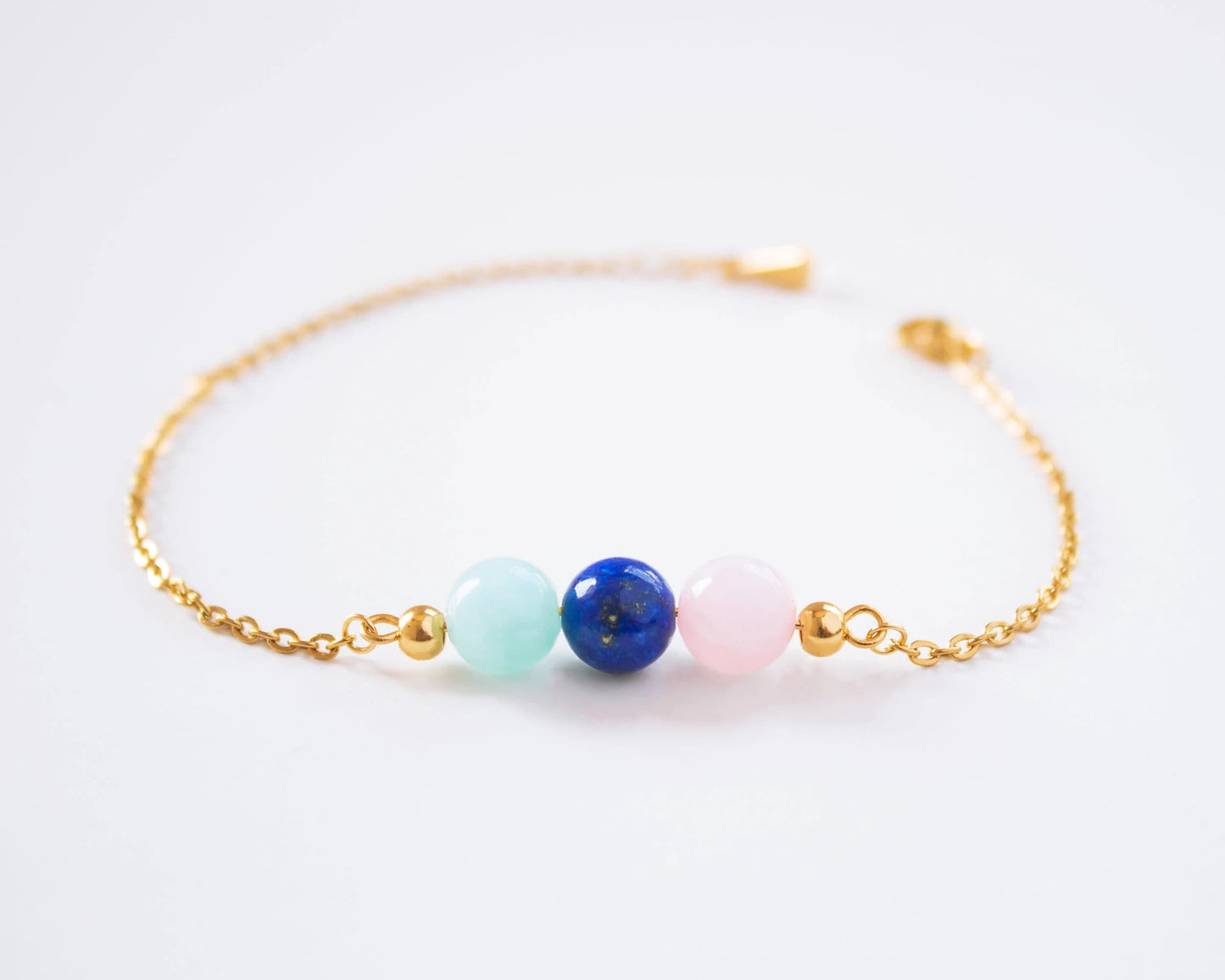 Healing gemstone bracelet with rose quartz and lapis lazuli worn on wrist