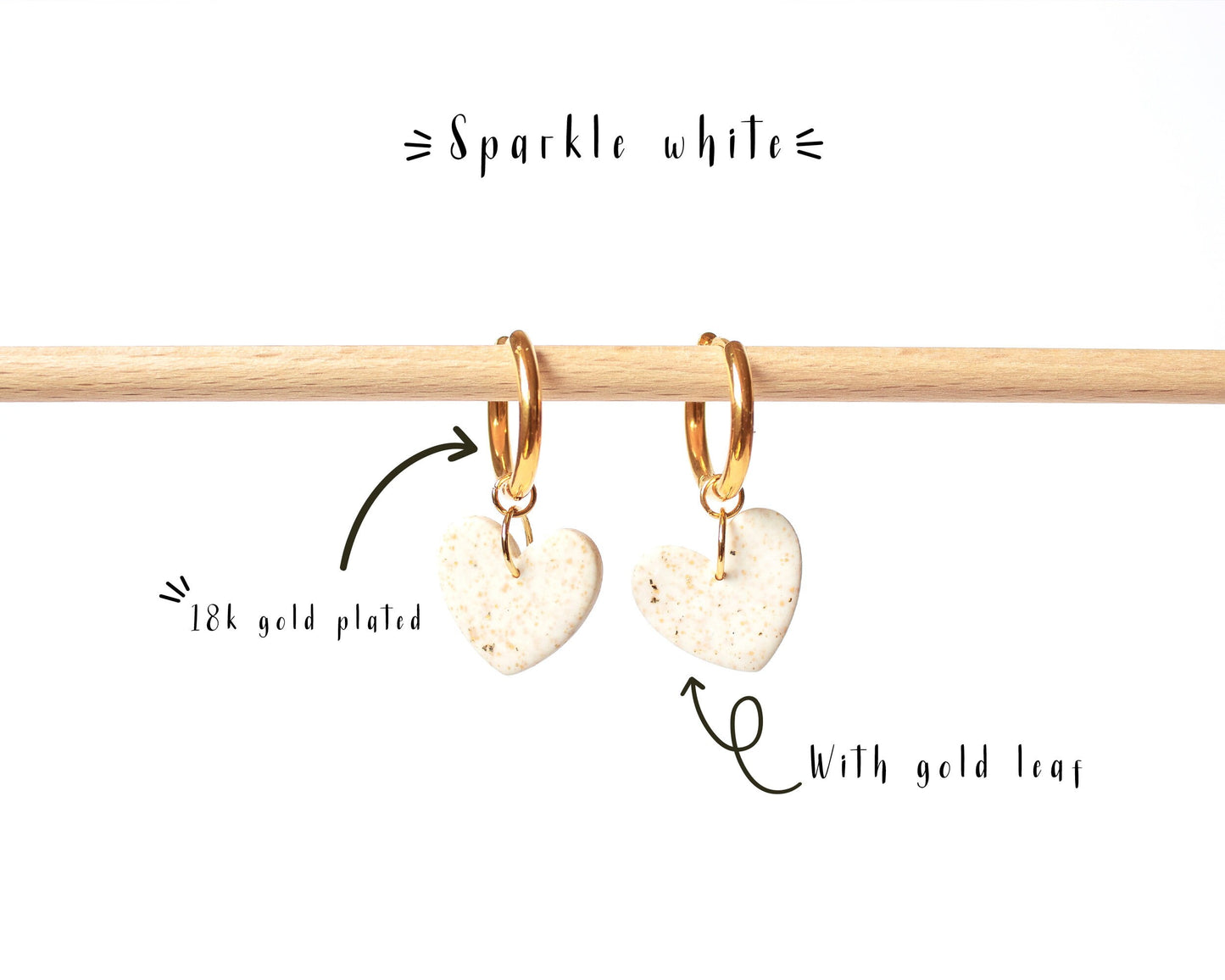 White heart charm hoop earrings with gold leaf details, handmade and nickel-free.