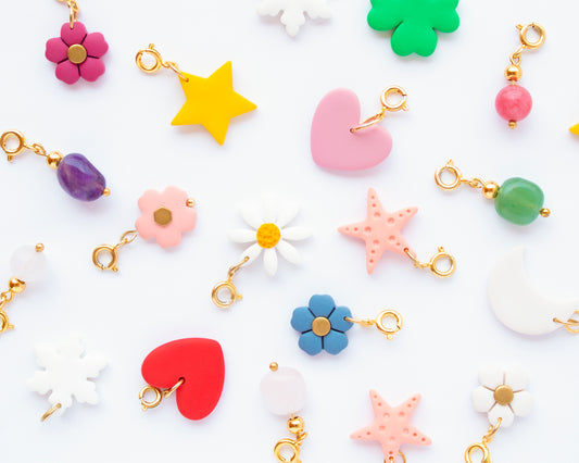 Add-on charms for necklaces and bracelets, handmade with clay and gold clasp, shown in fruit, ocean and gemstone designs.