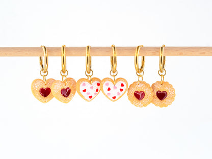 Cookie charm hoop earrings with heart shaped biscuit charms hanging on gold hoops