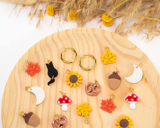 Interchangeable fall charm hoop earrings with hypoallergenic gold-plated hoops and autumn charms.