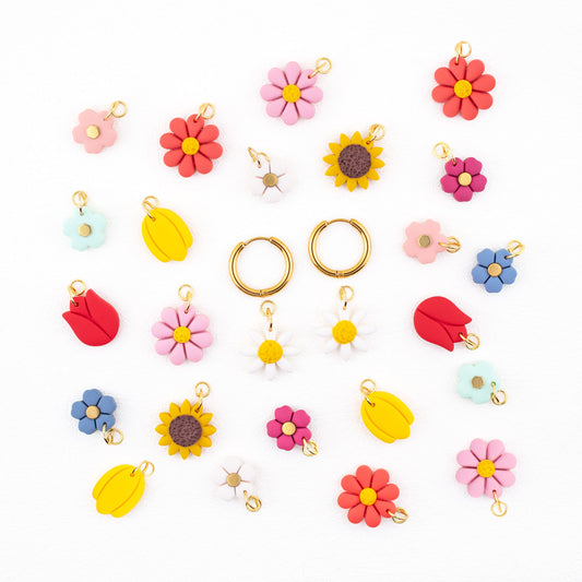 Hoop earrings with interchangeable charms featuring flowers, daisies, tulips, sunflowers, and colorful flowers.