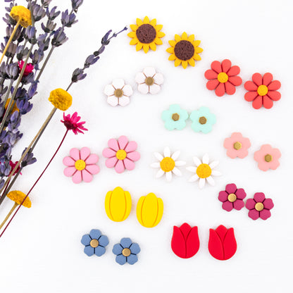 clay flower earrings are the perfect floral touch for any outfit! Choose from daisies, tulips, sunflowers, and colorful flowers to mix and match and create your own look.