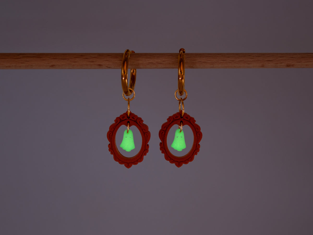 Handmade Halloween charm hoop earrings featuring cute ghost pendants inside red vintage frames on a bright background.