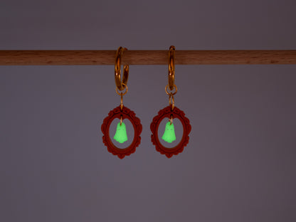 Handmade Halloween charm hoop earrings featuring cute ghost pendants inside red vintage frames on a bright background.