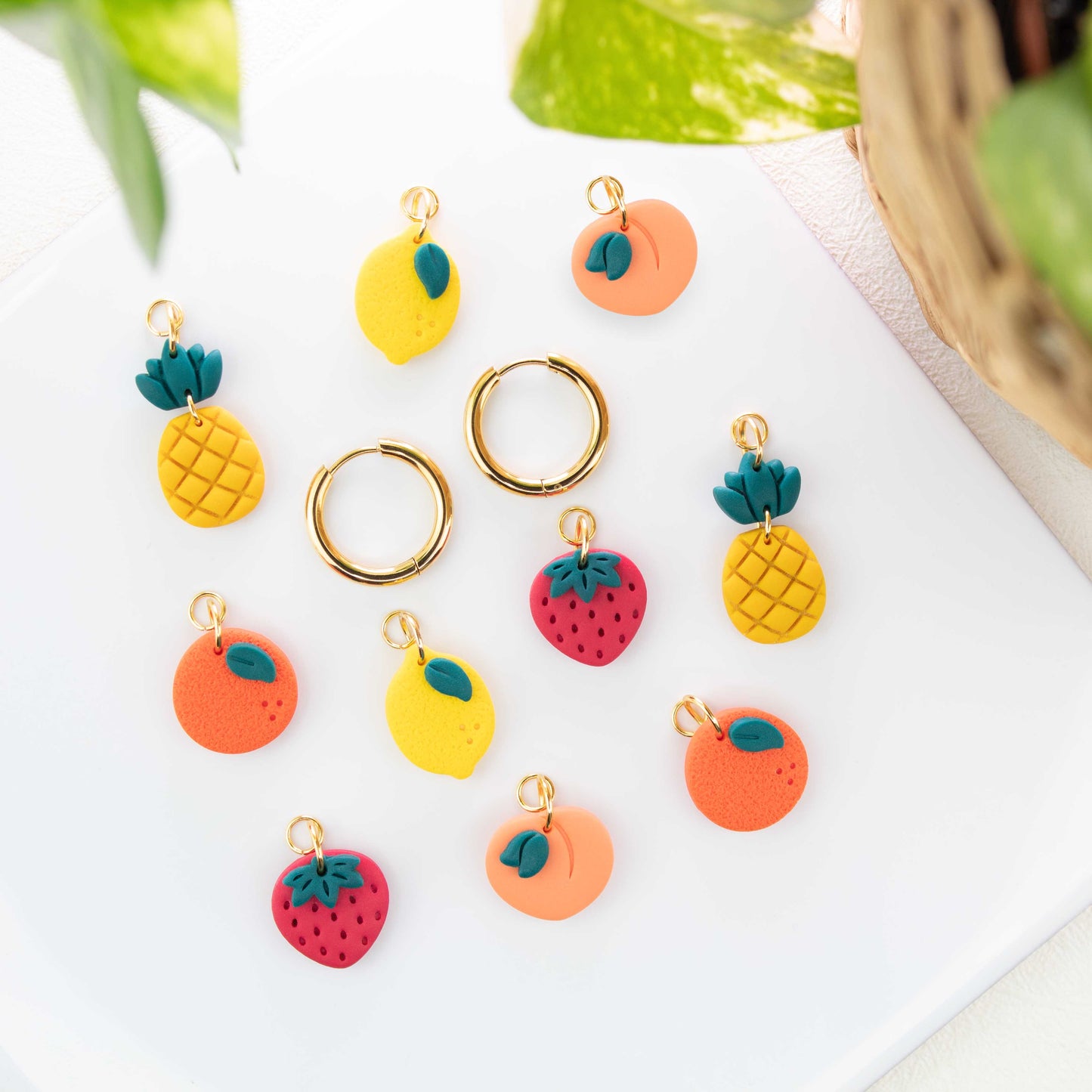 gold charm hoop earrings with fruit charms peach lemon strawberry pineapple orange