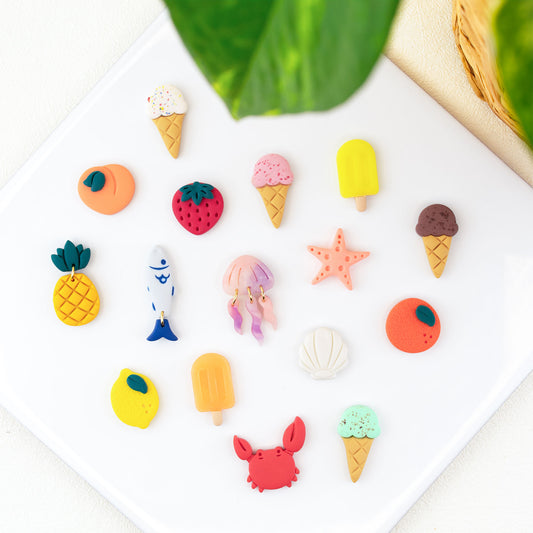 Handmade summer stud earrings in clay featuring seashell studs, starfish earrings, crab earrings, jellyfish studs, fish earrings, pink ice cream cone studs, chocolate ice cream studs, sprinkle ice cream earrings, mint ice cream studs, yellow popsicle studs, orange popsicle earrings, lemon stud earrings, peach studs, orange earrings, pineapple studs and strawberry earrings