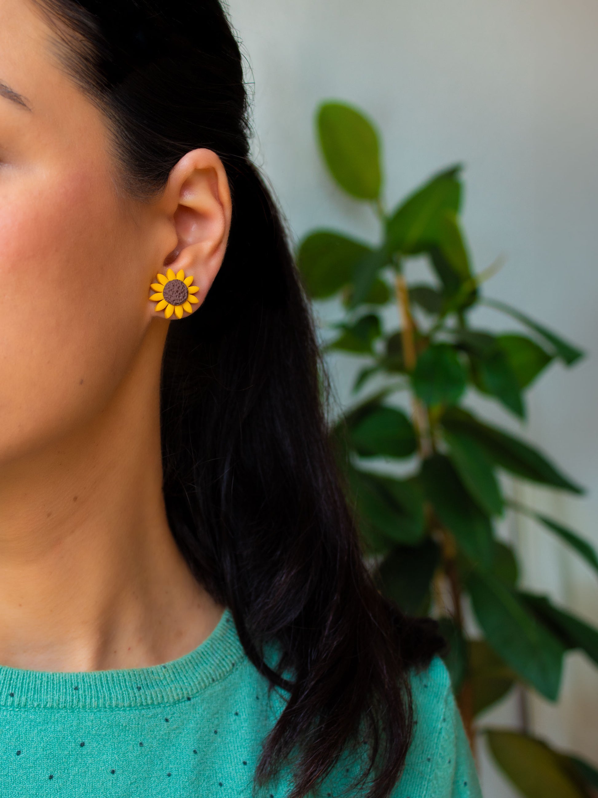Model with sunflower stud earrings