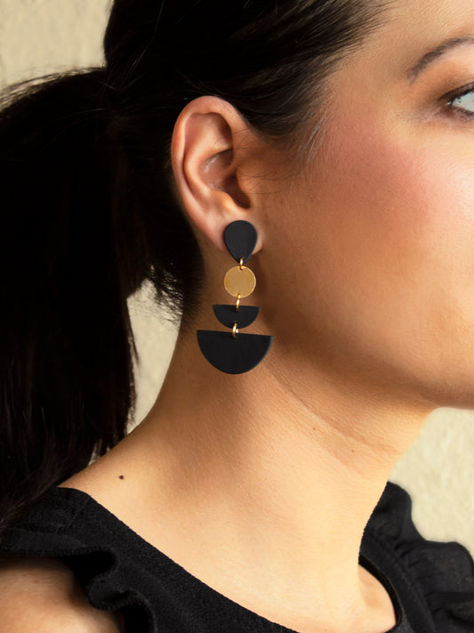 Model wearing black geometric dangle earrings with gold accents, highlighting the elegant boho style with 925 sterling silver posts.