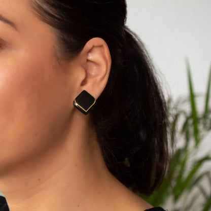 Elegant black clay stud earrings handmade in Art Deco style with gold accent