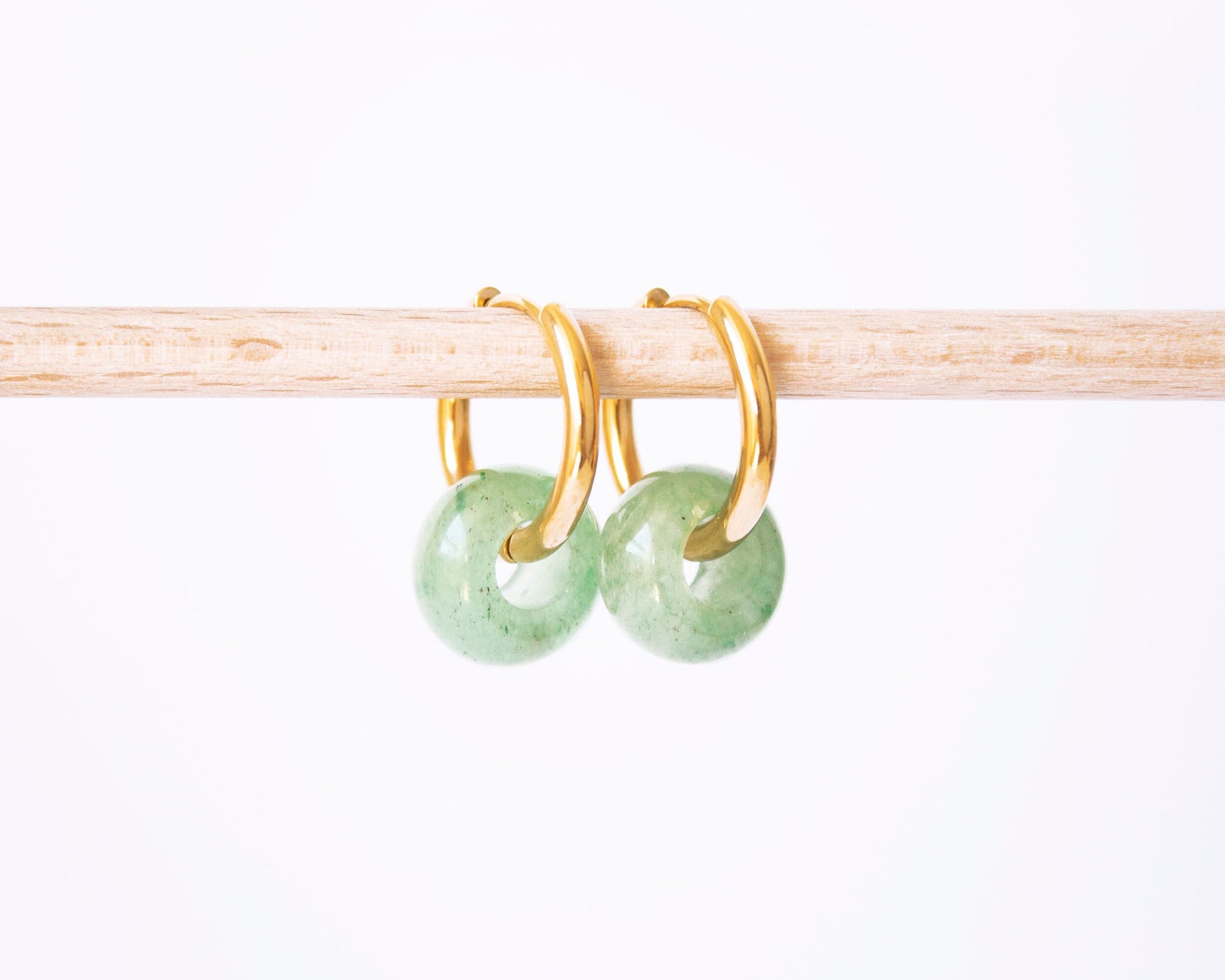 Minimalist gold hoop earrings with green Aventurine donut gemstone charms.
