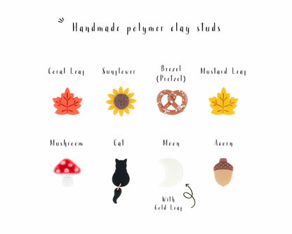 Displaying 8 unique handmade fall stud earrings, including pretzel, sunflower, leaf, moon, acorn, and black cat designs.