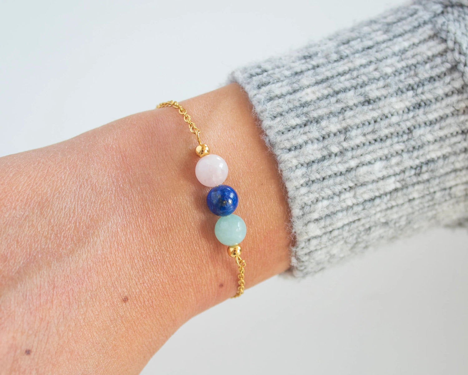 Healing bracelet with colorful gemstones on woman's wrist