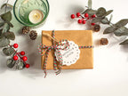 Gift wrapping option with kraft paper box red and green twine branded tag and message card