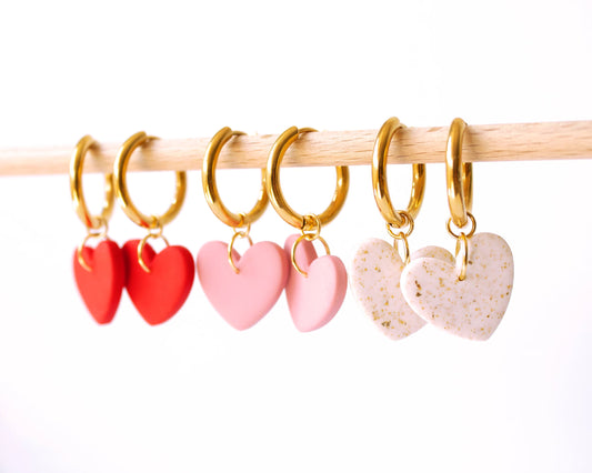 Gold hoop earrings with red, pink, and white heart clay charms, handmade and lightweight.